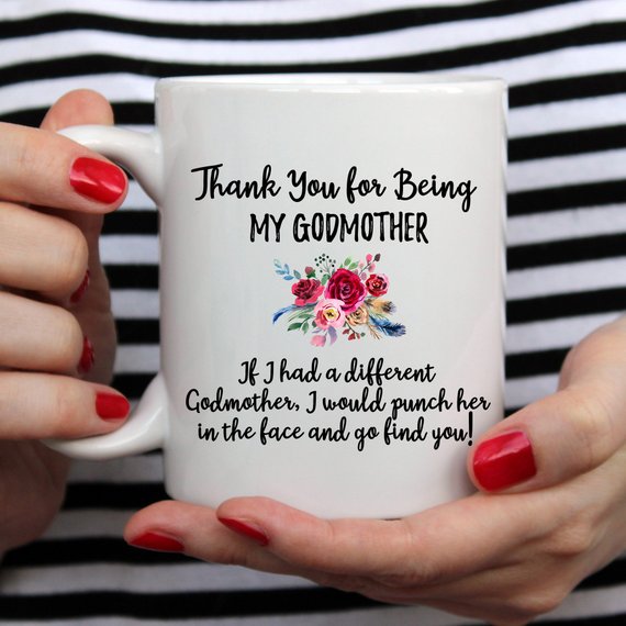 A beautiful white ceramic mug designed for godmothers, featuring a heartfelt message printed on both sides.