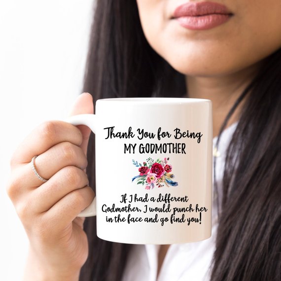 A beautiful white ceramic mug designed for godmothers, featuring a heartfelt message printed on both sides.