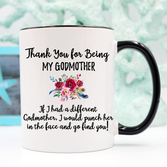 A beautiful white ceramic mug designed for godmothers, featuring a heartfelt message printed on both sides.