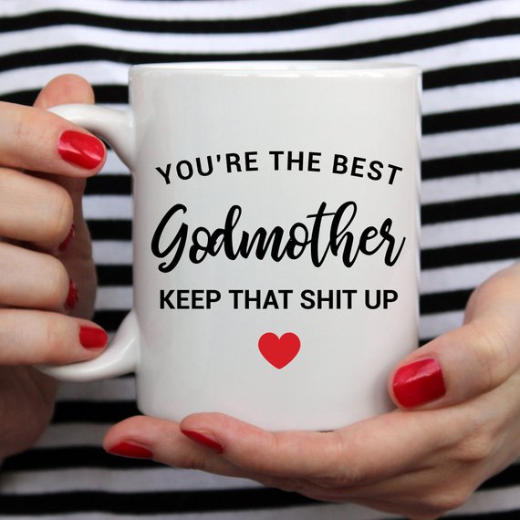A beautiful white ceramic mug designed for godmothers, featuring a heartfelt message printed on both sides.
