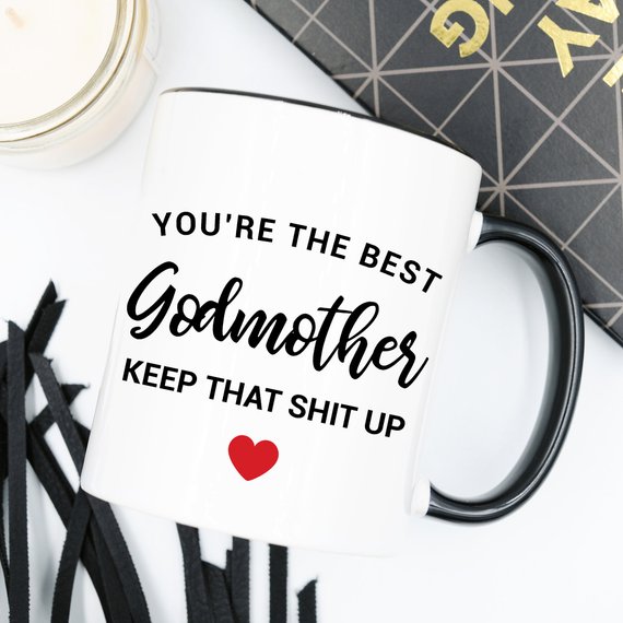 A beautiful white ceramic mug designed for godmothers, featuring a heartfelt message printed on both sides.