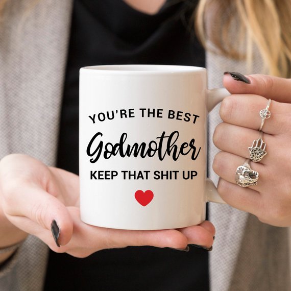 A beautiful white ceramic mug designed for godmothers, featuring a heartfelt message printed on both sides.