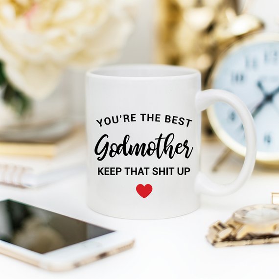 A beautiful white ceramic mug designed for godmothers, featuring a heartfelt message printed on both sides.