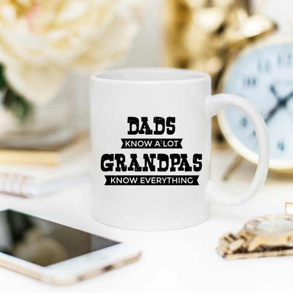 Funny coffee mug for Grandpa with the phrase 'Dads Know A Lot, Grandpas Know Everything' printed on it, showcasing a humorous design.