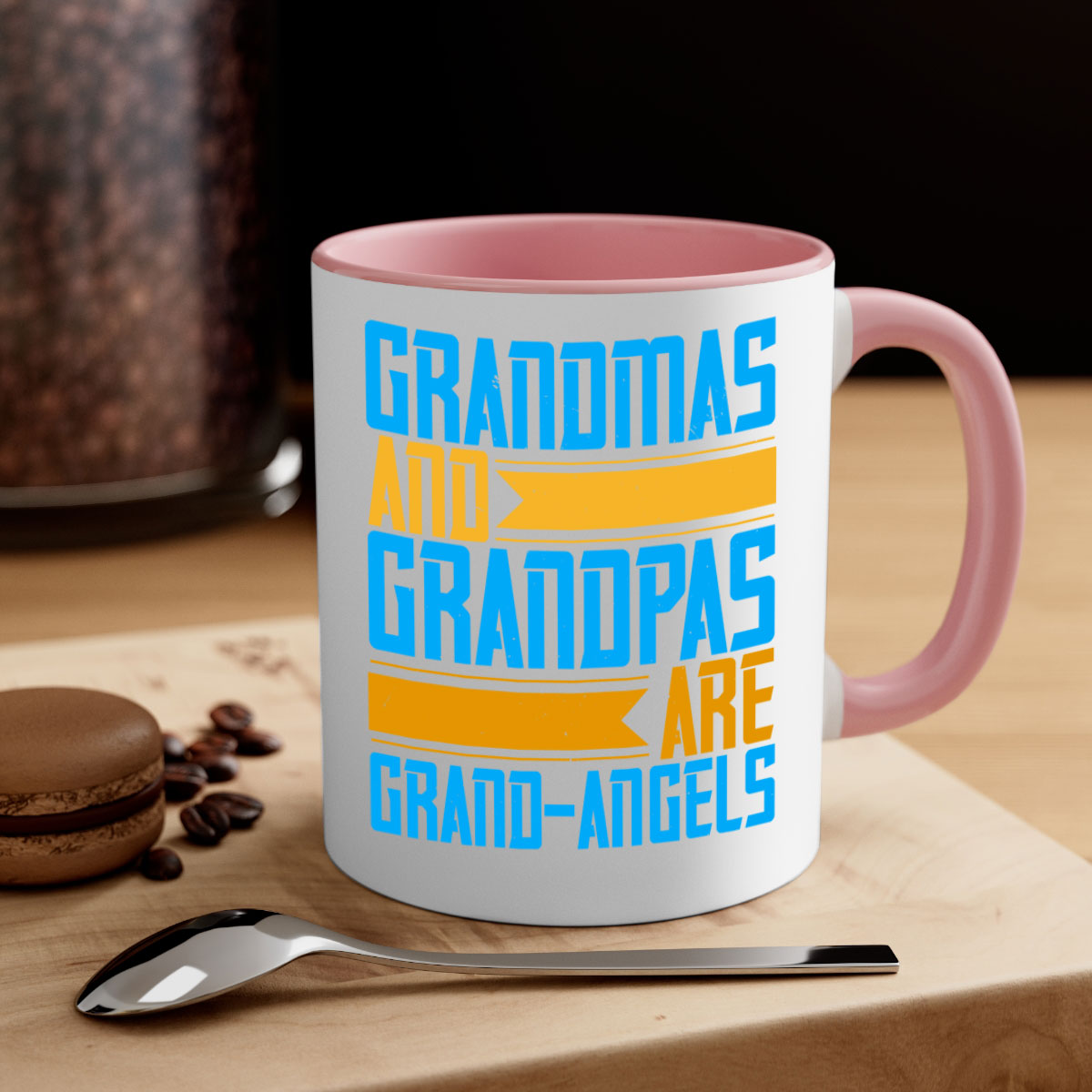 A two-tone ceramic coffee mug with a colored handle and interior, featuring the text 'Grandmas and grandpas are grandangels' in a stylish font.