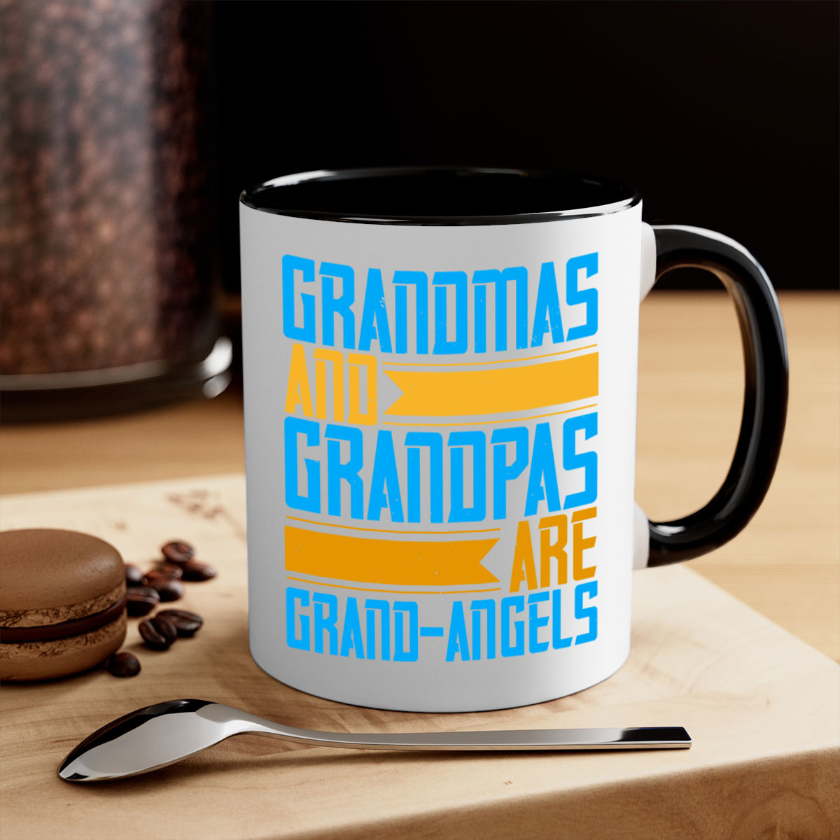 A two-tone ceramic coffee mug with a colored handle and interior, featuring the text 'Grandmas and grandpas are grandangels' in a stylish font.