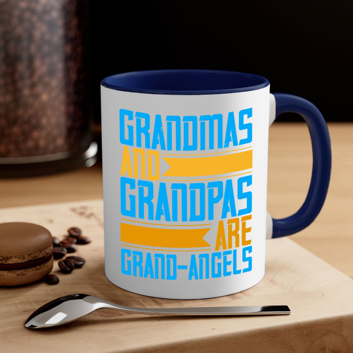 A two-tone ceramic coffee mug with a colored handle and interior, featuring the text 'Grandmas and grandpas are grandangels' in a stylish font.