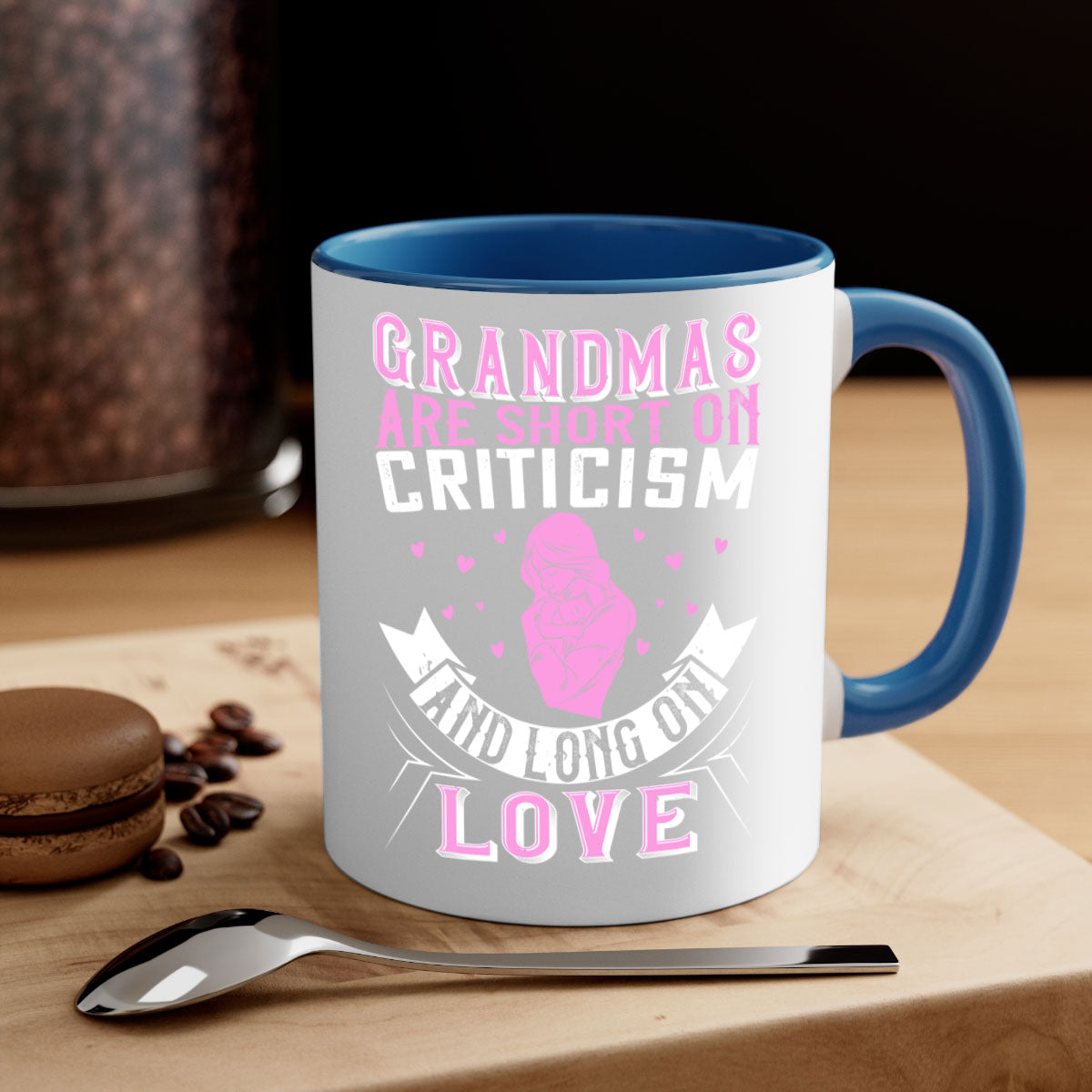 Ceramic mug with the phrase 'Grandmas are Short on Criticism and Long on Love', featuring a glossy finish and colorful handle.
