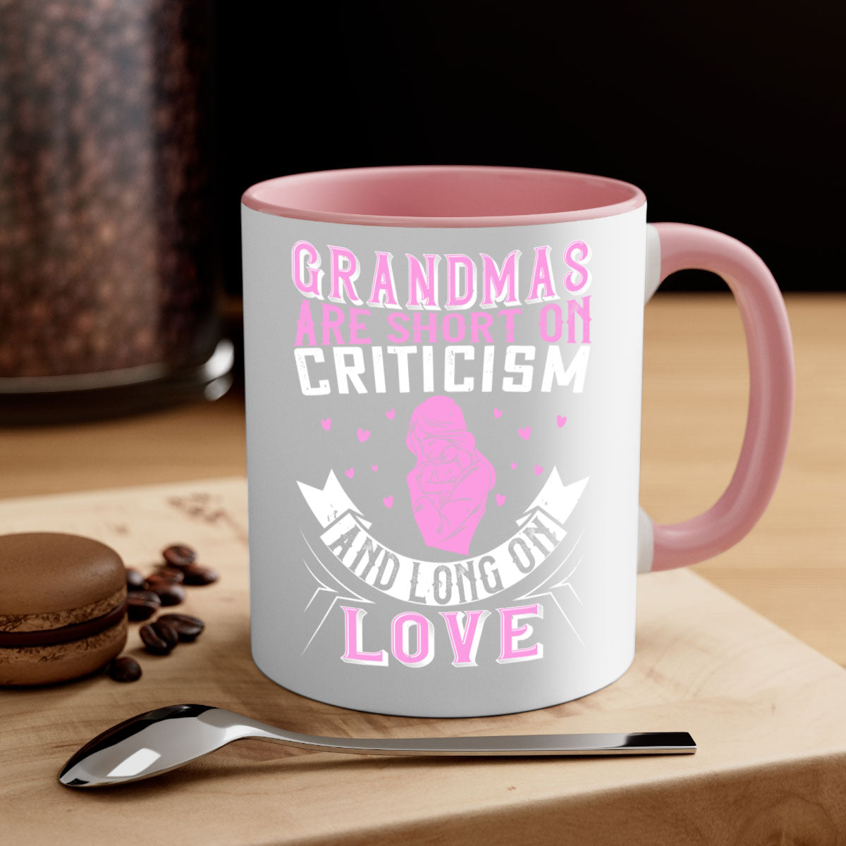 Ceramic mug with the phrase 'Grandmas are Short on Criticism and Long on Love', featuring a glossy finish and colorful handle.