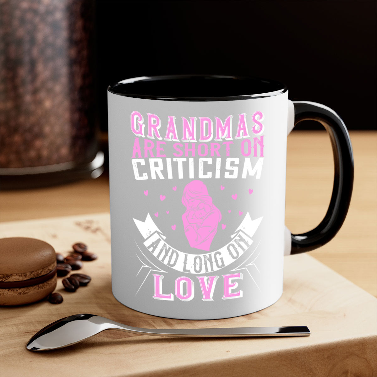 Ceramic mug with the phrase 'Grandmas are Short on Criticism and Long on Love', featuring a glossy finish and colorful handle.