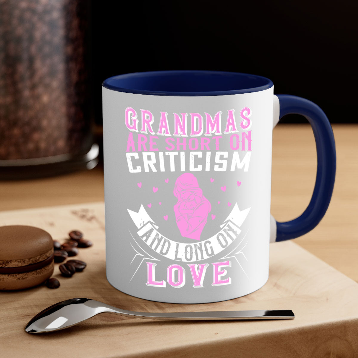 Ceramic mug with the phrase 'Grandmas are Short on Criticism and Long on Love', featuring a glossy finish and colorful handle.