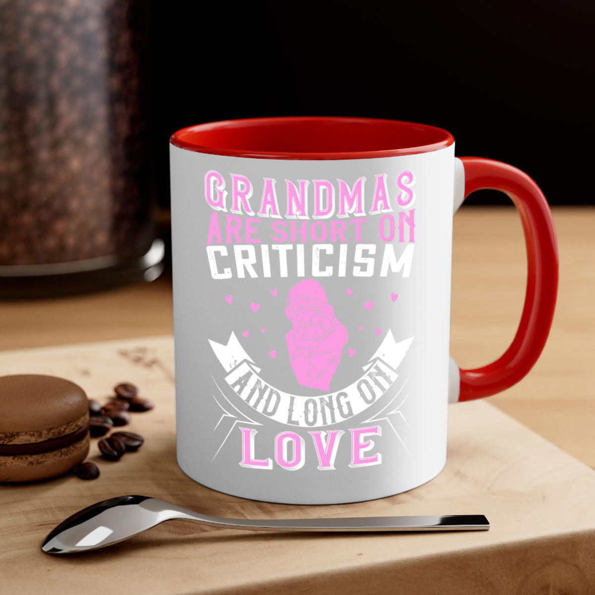 Ceramic mug with the phrase 'Grandmas are Short on Criticism and Long on Love', featuring a glossy finish and colorful handle.