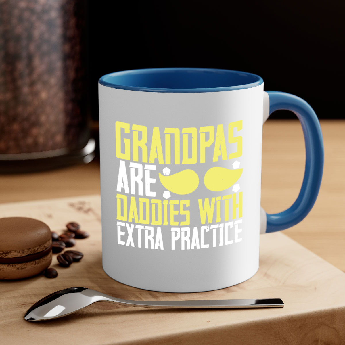 Two-tone ceramic coffee mug with a humorous design saying 'Grandpas are daddies with extra practice', featuring a colored handle and glossy finish.