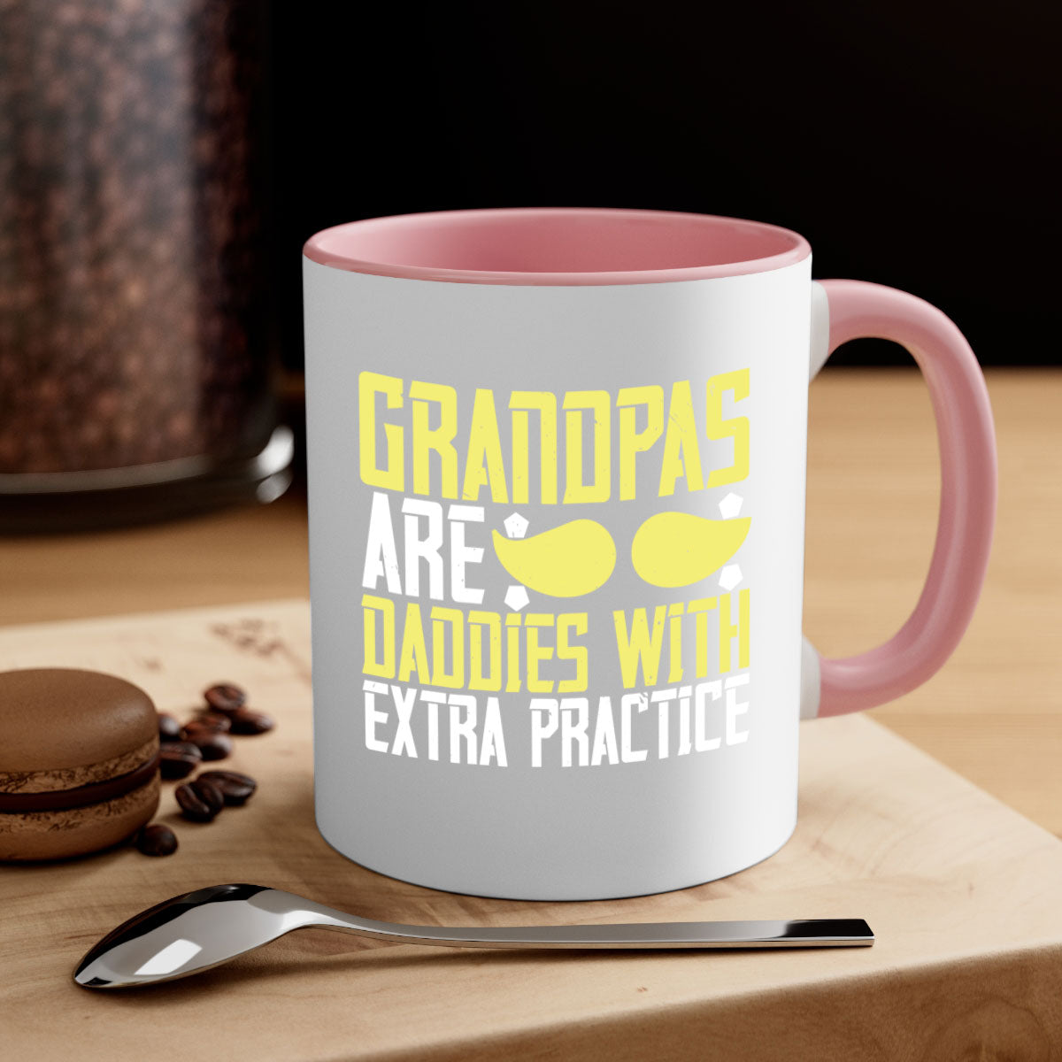 Two-tone ceramic coffee mug with a humorous design saying 'Grandpas are daddies with extra practice', featuring a colored handle and glossy finish.