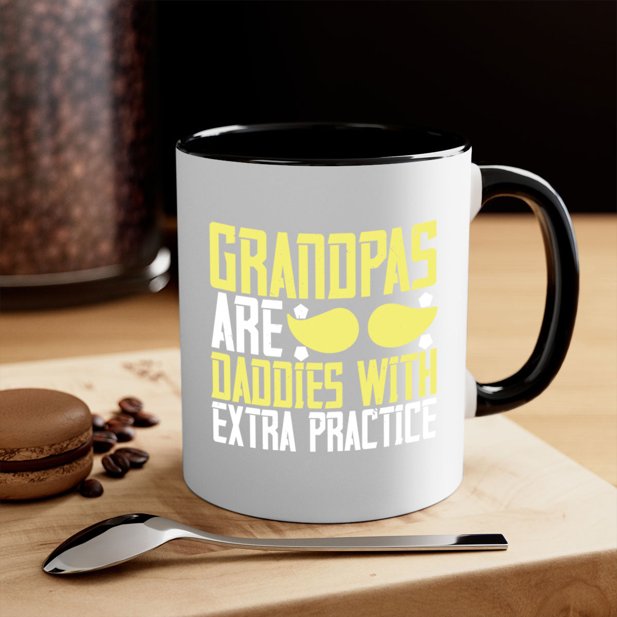 Two-tone ceramic coffee mug with a humorous design saying 'Grandpas are daddies with extra practice', featuring a colored handle and glossy finish.