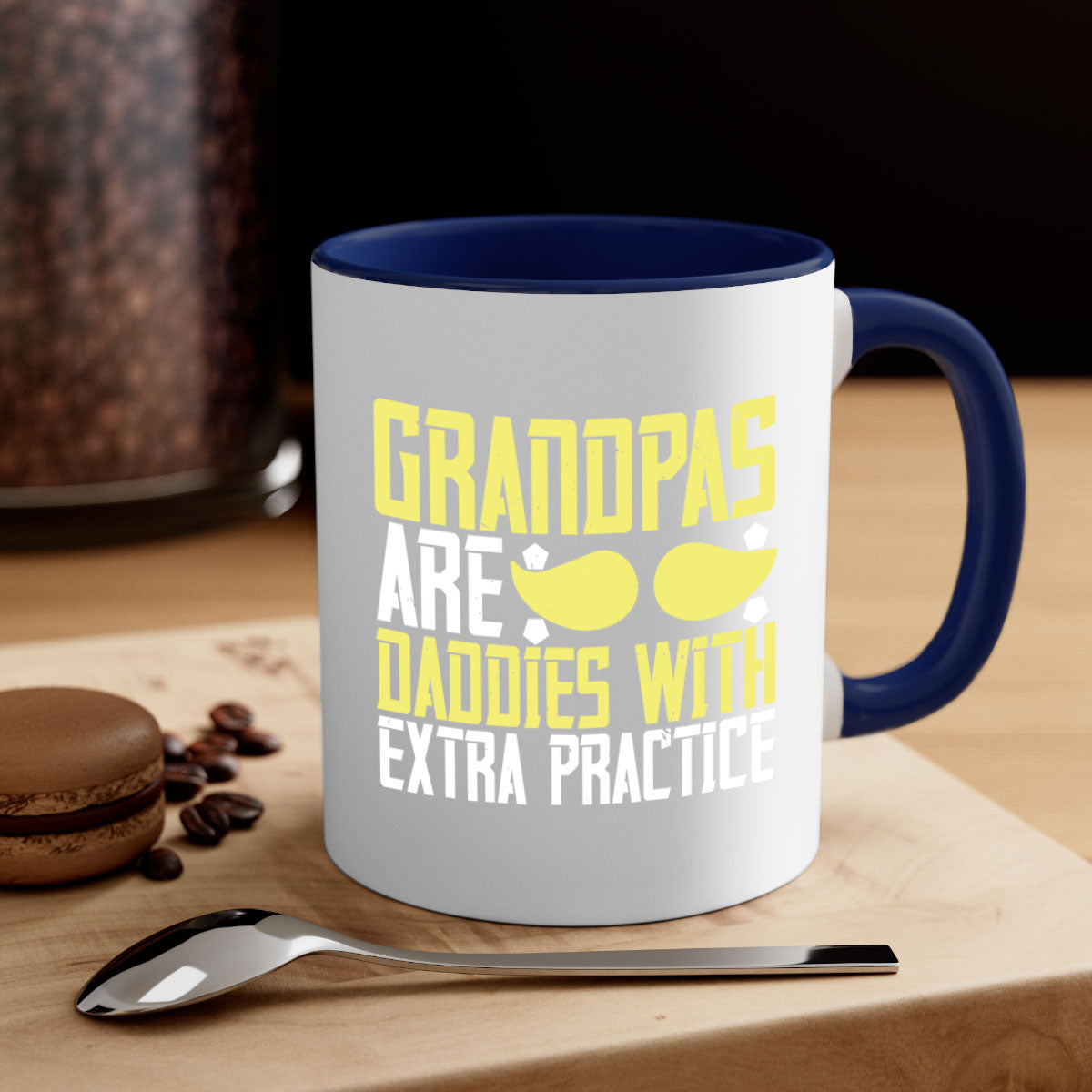 Two-tone ceramic coffee mug with a humorous design saying 'Grandpas are daddies with extra practice', featuring a colored handle and glossy finish.