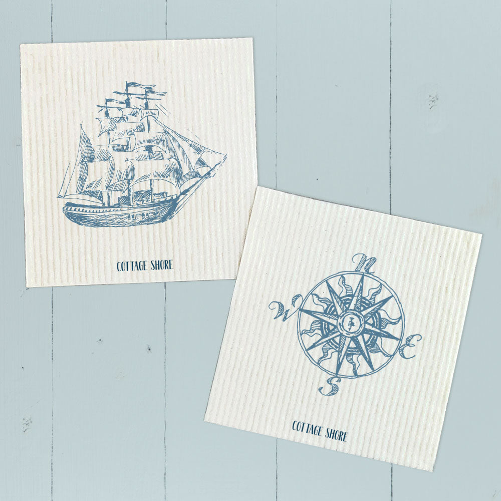 Two Swedish dish cloths featuring hand-drawn ship and compass designs, made from eco-friendly materials.