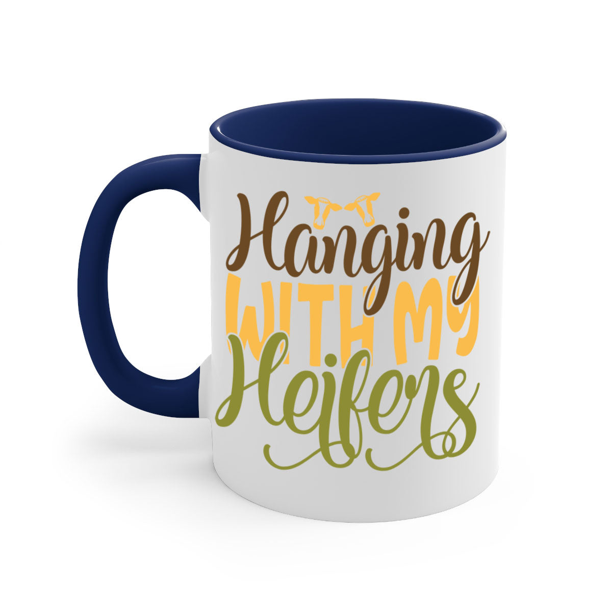 A two-tone ceramic mug with a colorful handle and interior, featuring the phrase 'Hanging with My Heifers' in a glossy finish.