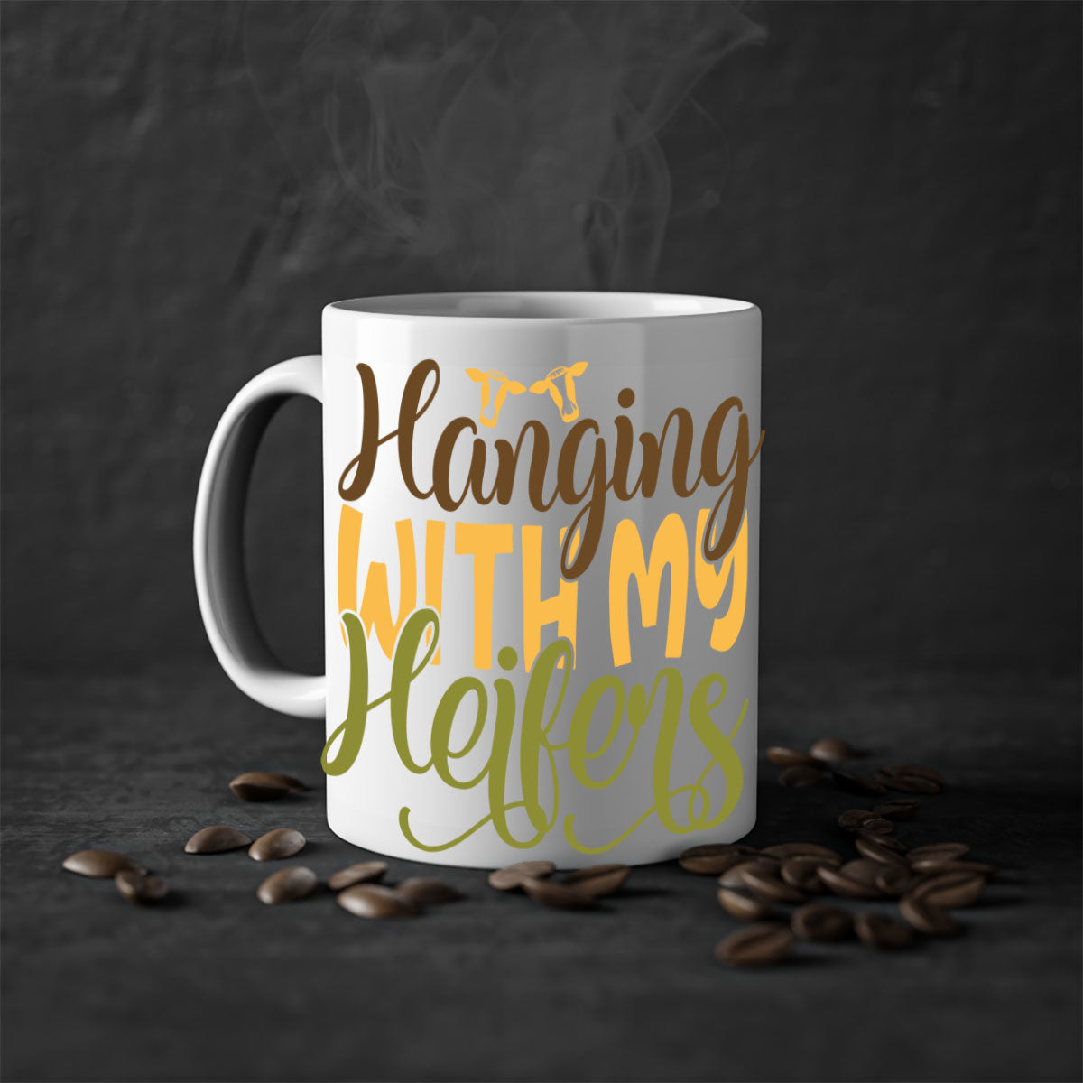 A two-tone ceramic mug with a colorful handle and interior, featuring the phrase 'Hanging with My Heifers' in a glossy finish.