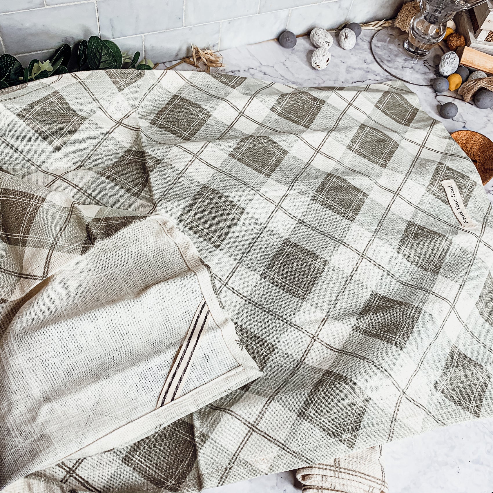 Happiness Is Home Set featuring a decorative dish towel and a wooden spoon with engraved sayings, perfect for gifting.