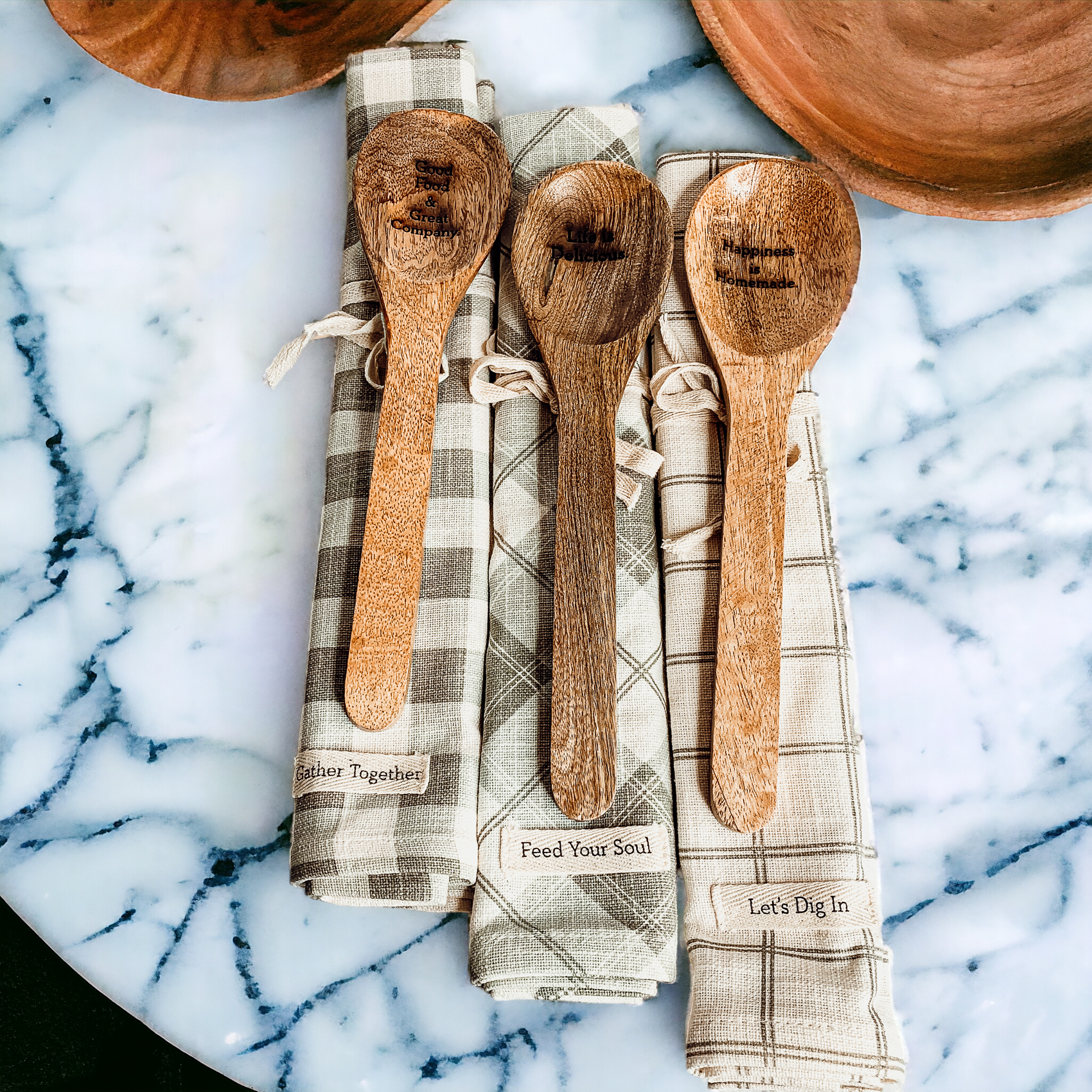 Happiness Is Home Set featuring a decorative dish towel and a wooden spoon with engraved sayings, perfect for gifting.