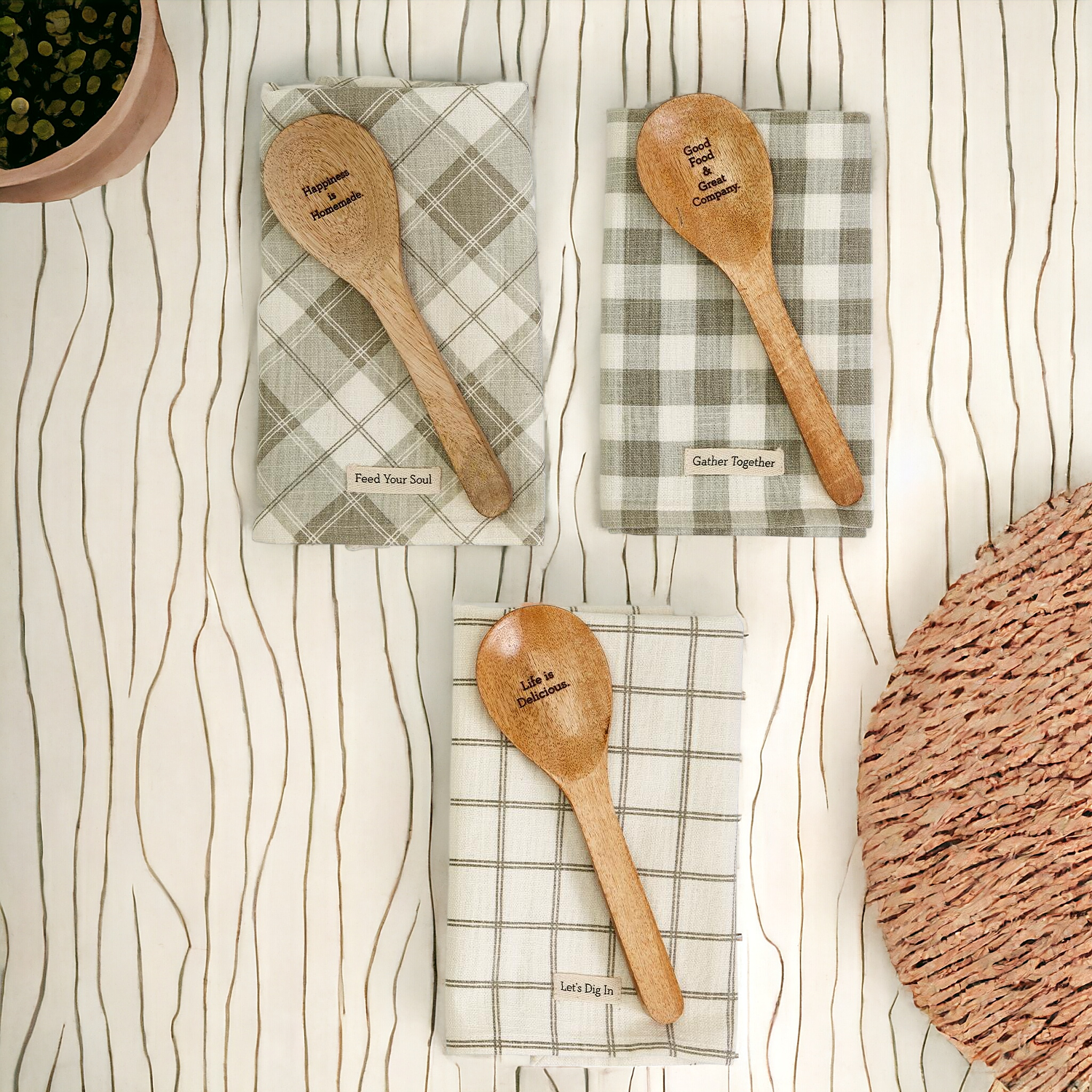 Happiness Is Home Set featuring a decorative dish towel and a wooden spoon with engraved sayings, perfect for gifting.