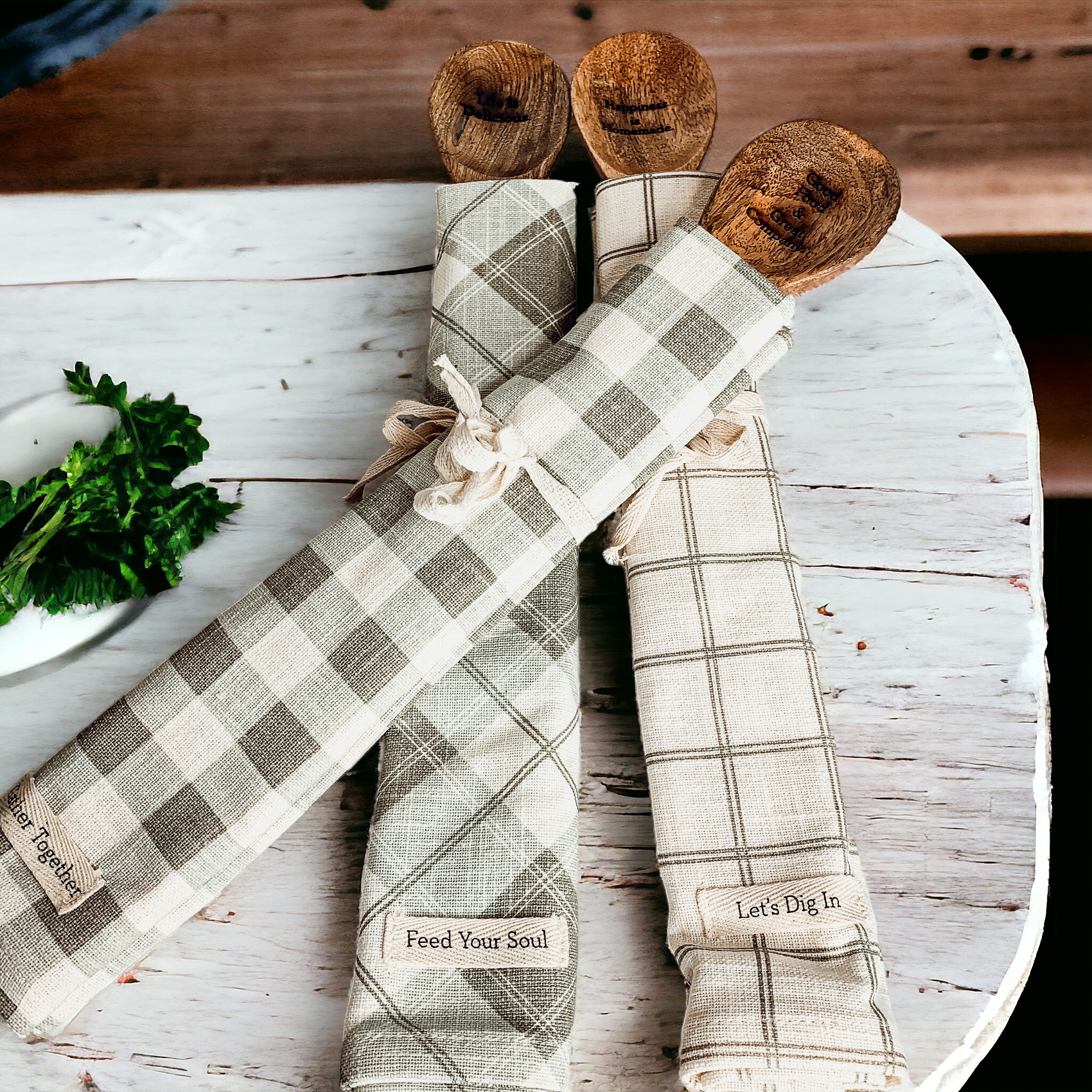 Happiness Is Home Set featuring a decorative dish towel and a wooden spoon with engraved sayings, perfect for gifting.