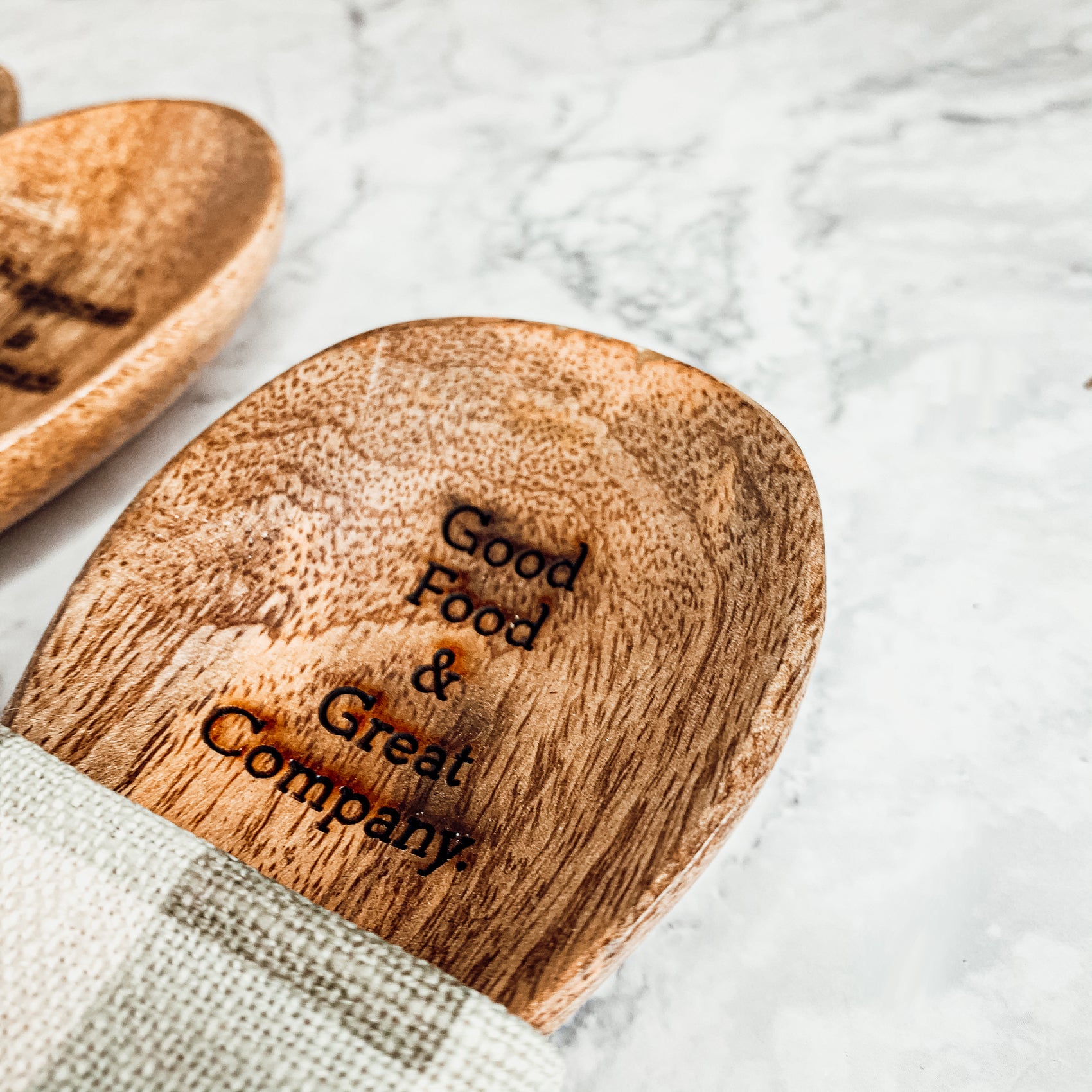 Happiness Is Home Set featuring a decorative dish towel and a wooden spoon with engraved sayings, perfect for gifting.