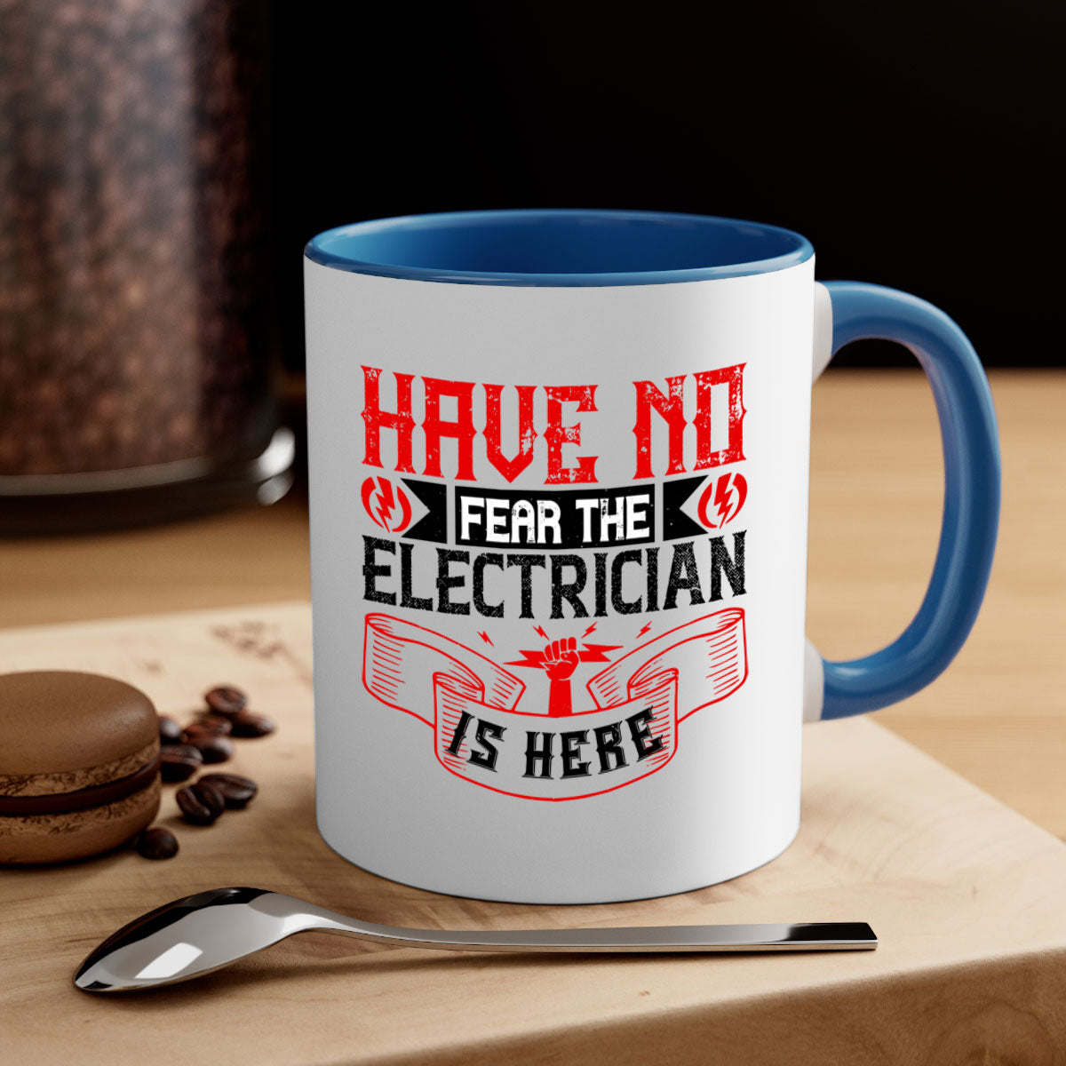 Two-tone ceramic mug with 'Have no fear the electrician is here' design, featuring a colored handle and glossy finish.