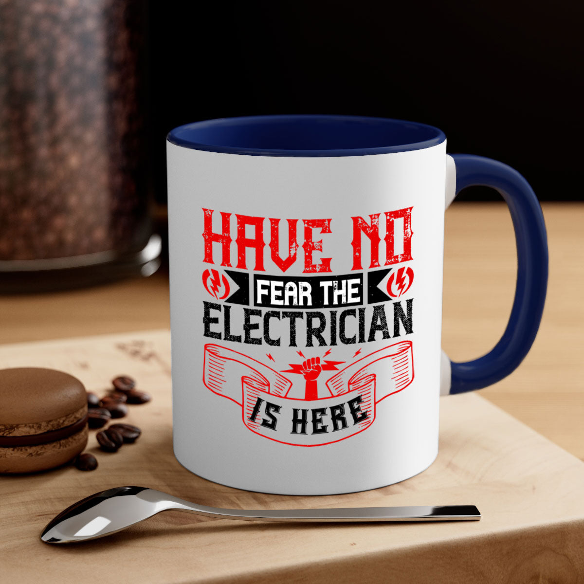 Two-tone ceramic mug with 'Have no fear the electrician is here' design, featuring a colored handle and glossy finish.