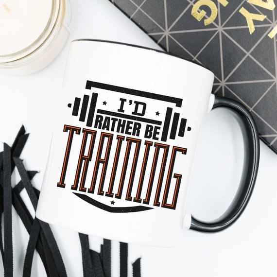 A humorous 'I'd Rather Be Training' coffee mug, showcasing a fun design perfect for fitness enthusiasts, crafted from high-quality ceramic.