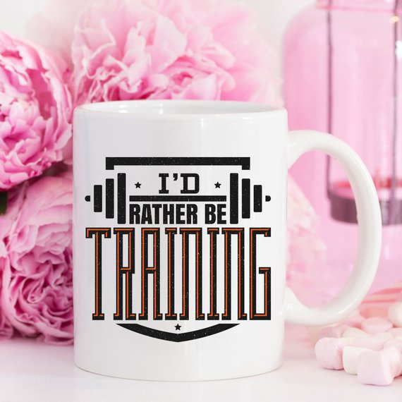 A humorous 'I'd Rather Be Training' coffee mug, showcasing a fun design perfect for fitness enthusiasts, crafted from high-quality ceramic.