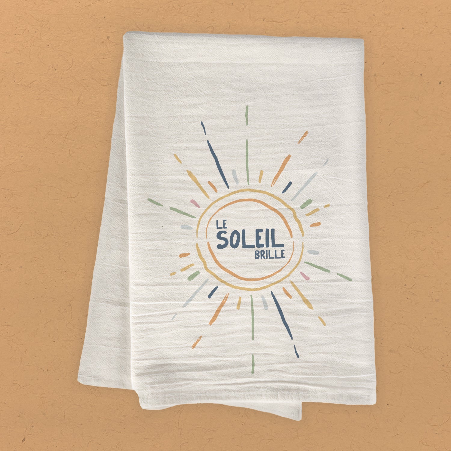 Le Soleil Brille cotton tea towel featuring vibrant sun design, made from 100% absorbent cotton, perfect for kitchen use.