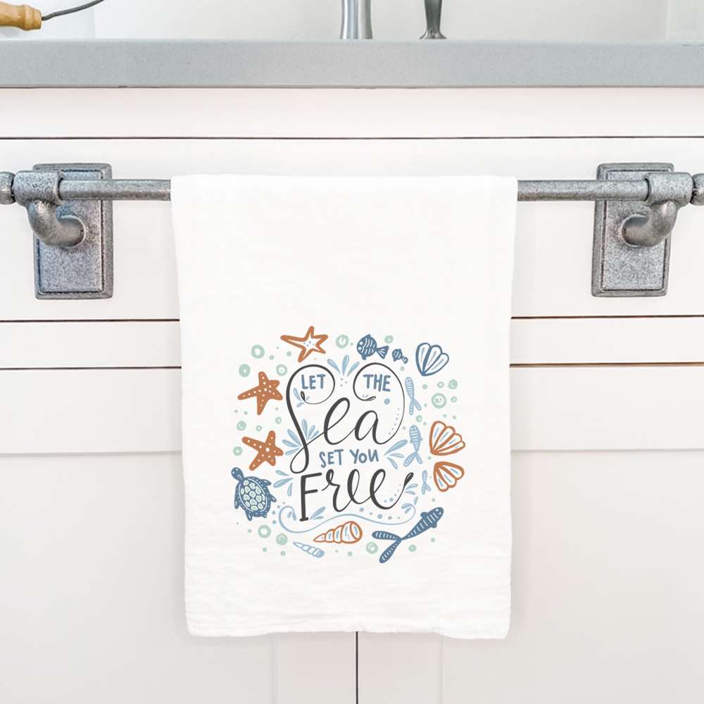 Let the Sea Set You Free cotton tea towel featuring vibrant ocean-themed design, perfect for kitchen use.