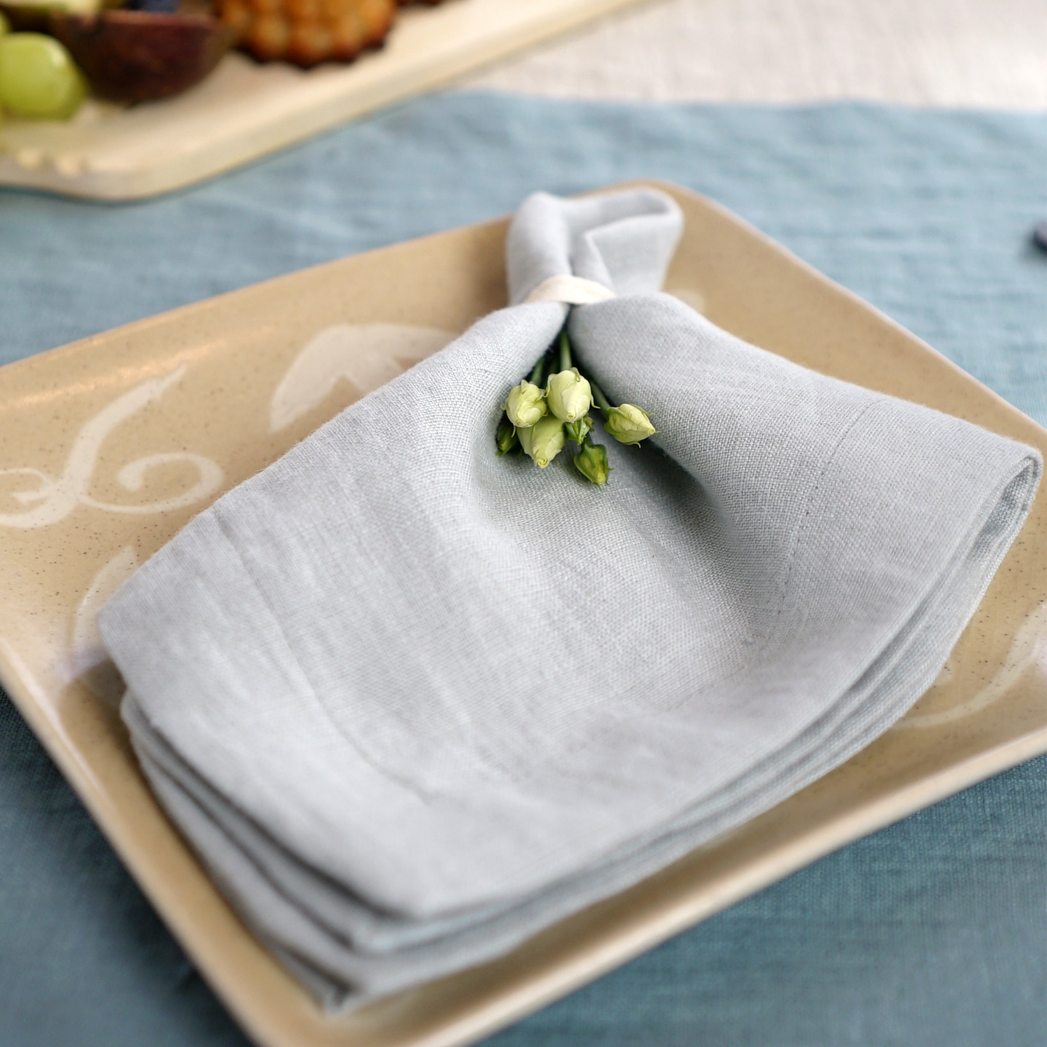 Light Grey linen napkins set, handcrafted from 100% stonewashed linen, featuring a decorative hem and a soft, luxurious texture.