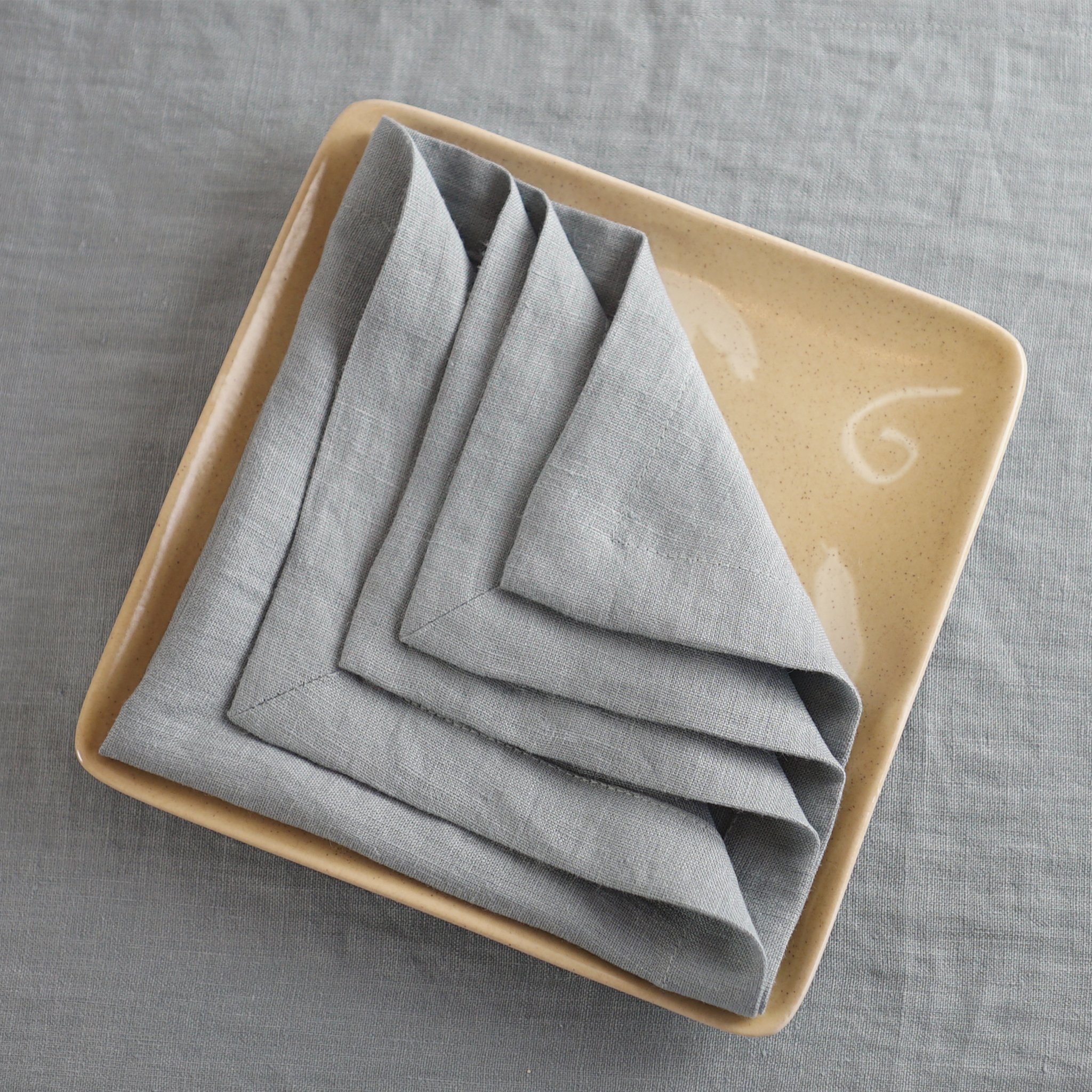 Light Grey linen napkins set, handcrafted from 100% stonewashed linen, featuring a decorative hem and a soft, luxurious texture.