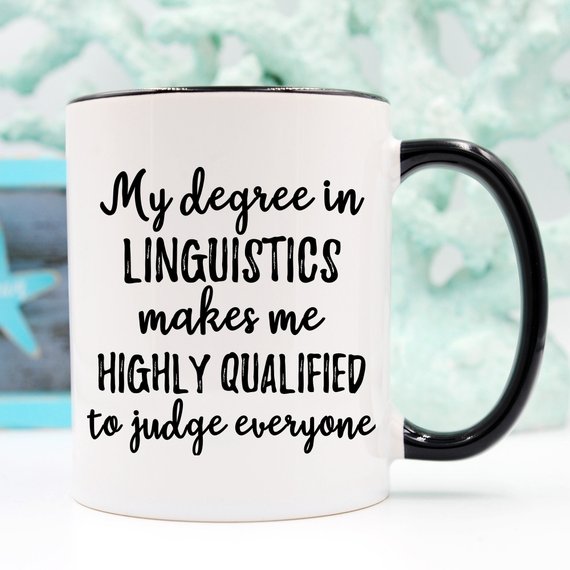 A stylish white linguistics mug featuring a vibrant design on both sides, perfect for coffee or tea lovers.