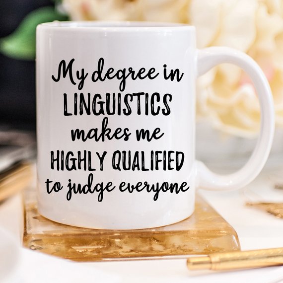 A stylish white linguistics mug featuring a vibrant design on both sides, perfect for coffee or tea lovers.