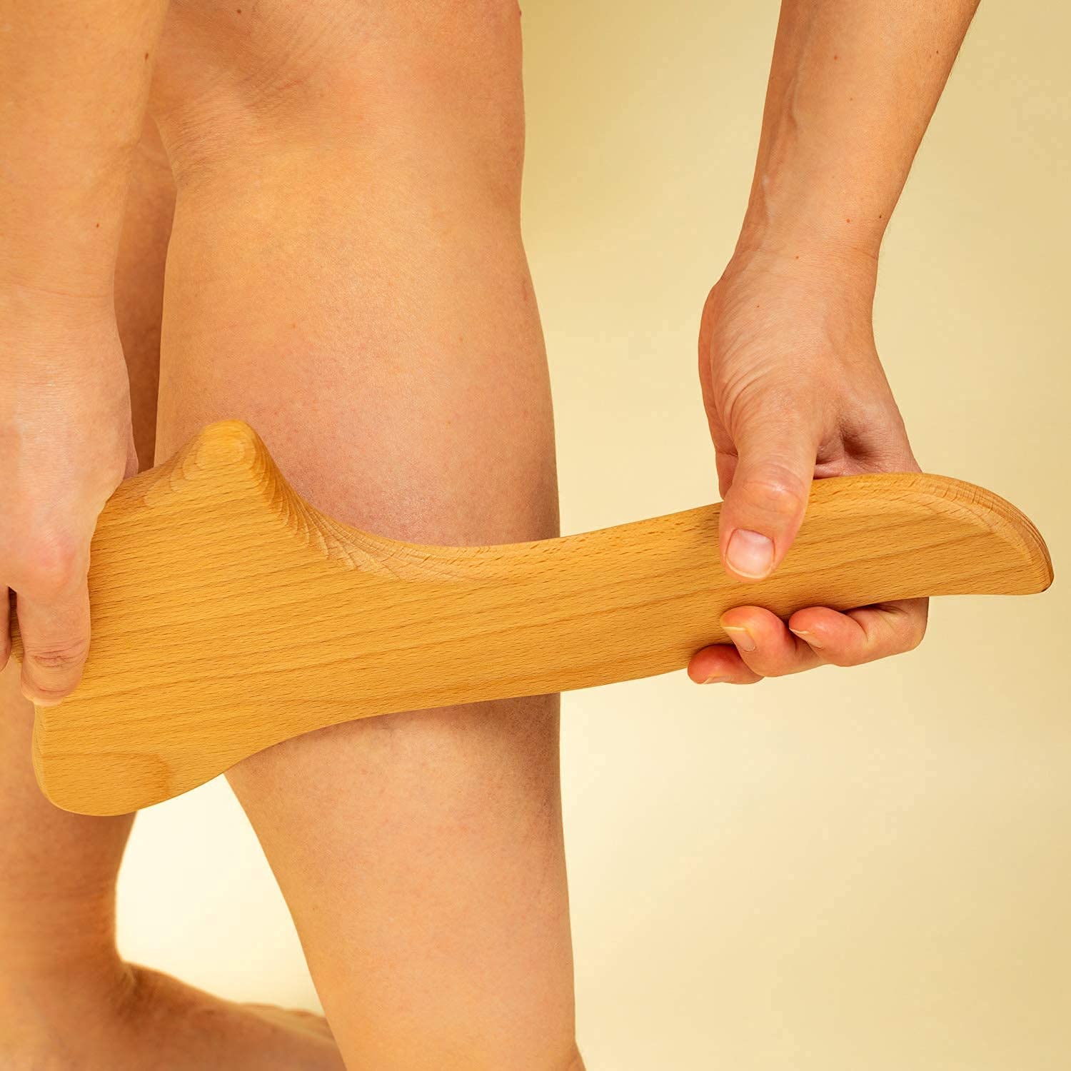 Lymphatic Drainage Paddle, an anti-cellulite Gua Sha tool made of wood, designed for massage and skin tightening.