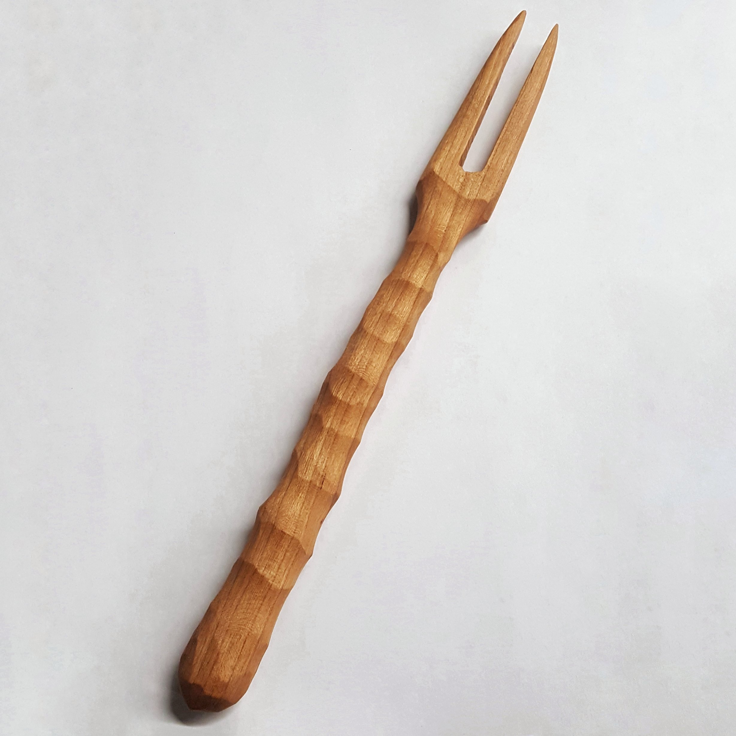 A stylish 2 pronged meat fork with a chiseled handle, ideal for serving charcuterie and appetizers.