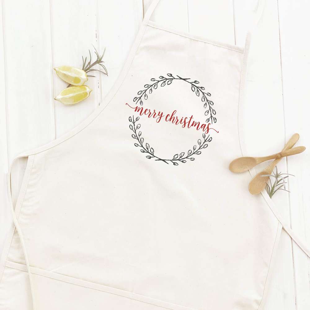 Merry Christmas Wreath Women's Apron featuring a festive design, adjustable neck, and divided front pocket, made from durable cotton canvas.