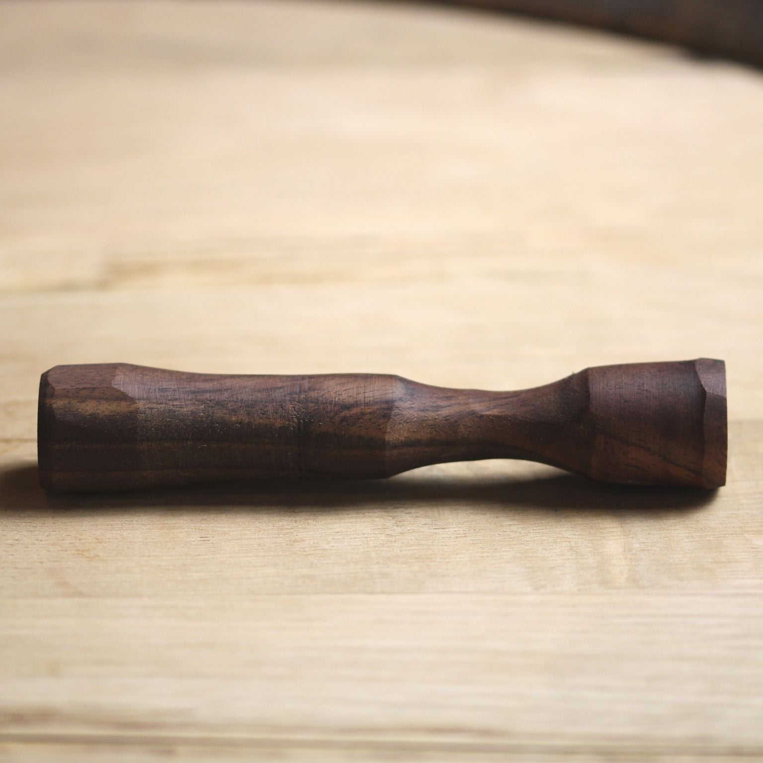 A handcrafted Mini-Muddler made from pre-fallen lumber, designed for in-glass cocktail preparation, showcasing its compact size and natural finish.