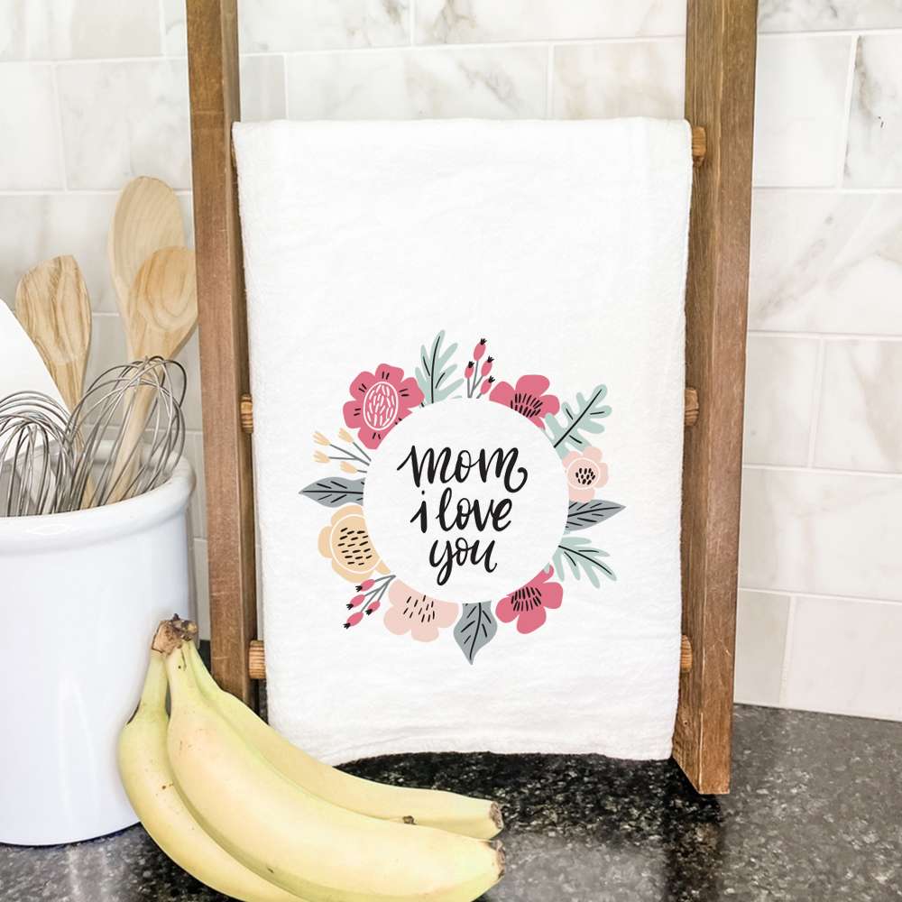 A vibrant cotton tea towel featuring a floral design with the text 'Mom I Love You', perfect for kitchen use.