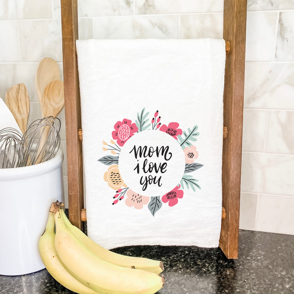 A vibrant cotton tea towel featuring a floral design with the text 'Mom I Love You', perfect for kitchen use.