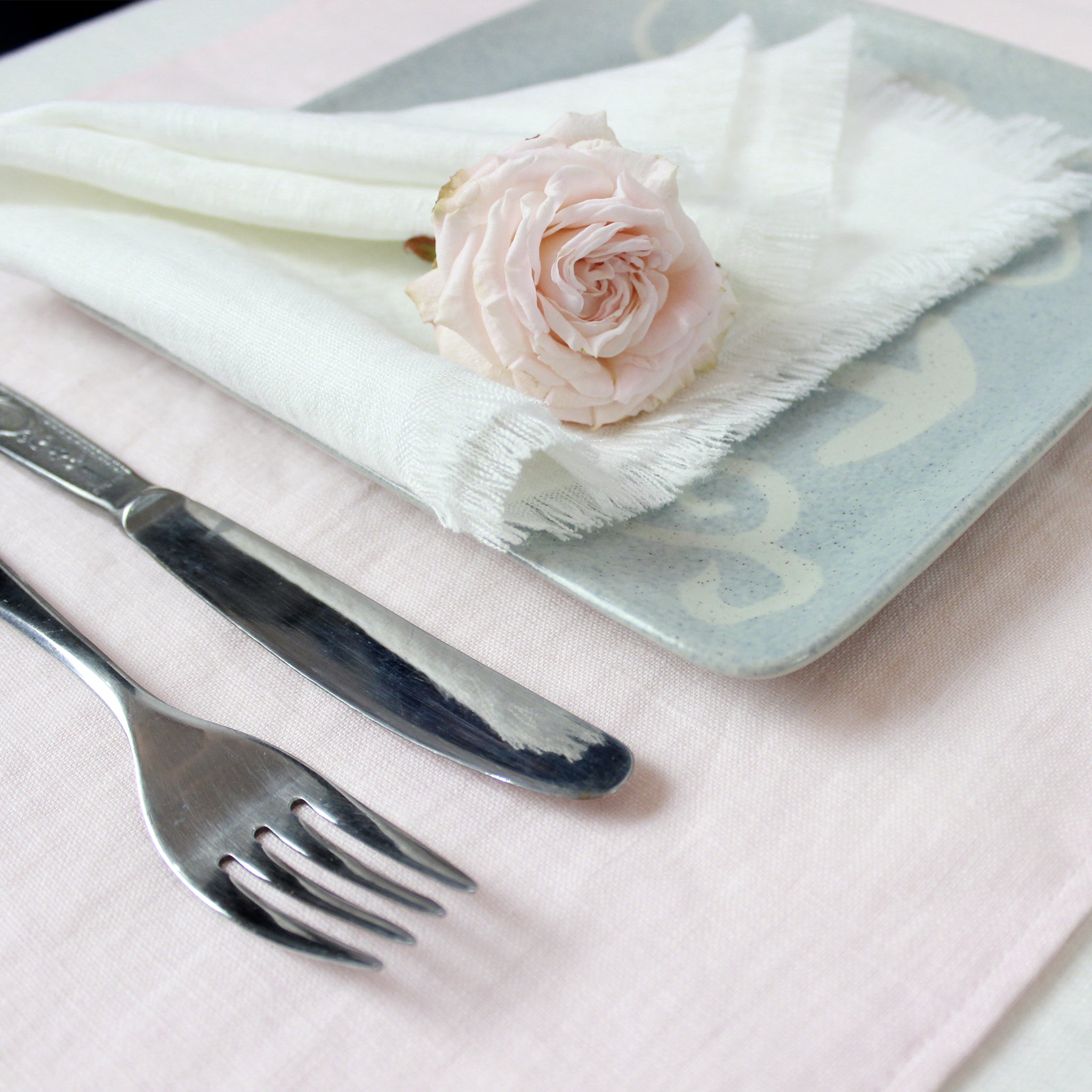 Set of two mustard linen napkins with tassels, showcasing a soft texture and elegant design, perfect for modern dining decor.