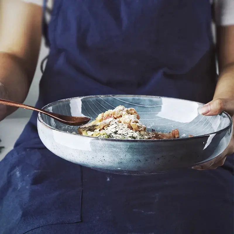 A beautifully handcrafted Naomi Bowl made from durable Jiarun porcelain, featuring a vibrant blue color and a lightweight design.