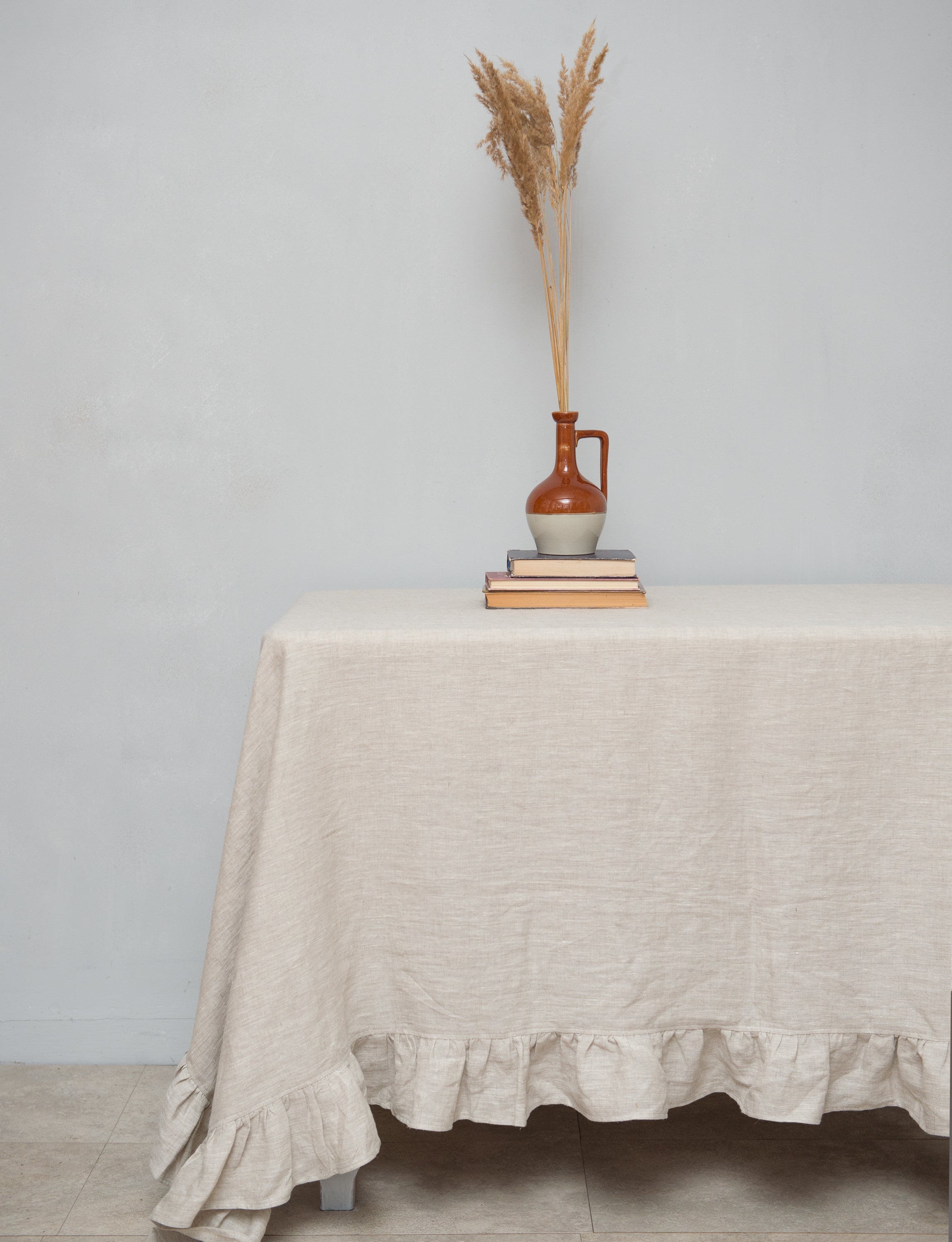 Natural Light linen tablecloth with elegant ruffles, showcasing high-quality European linen in a soft, inviting color.