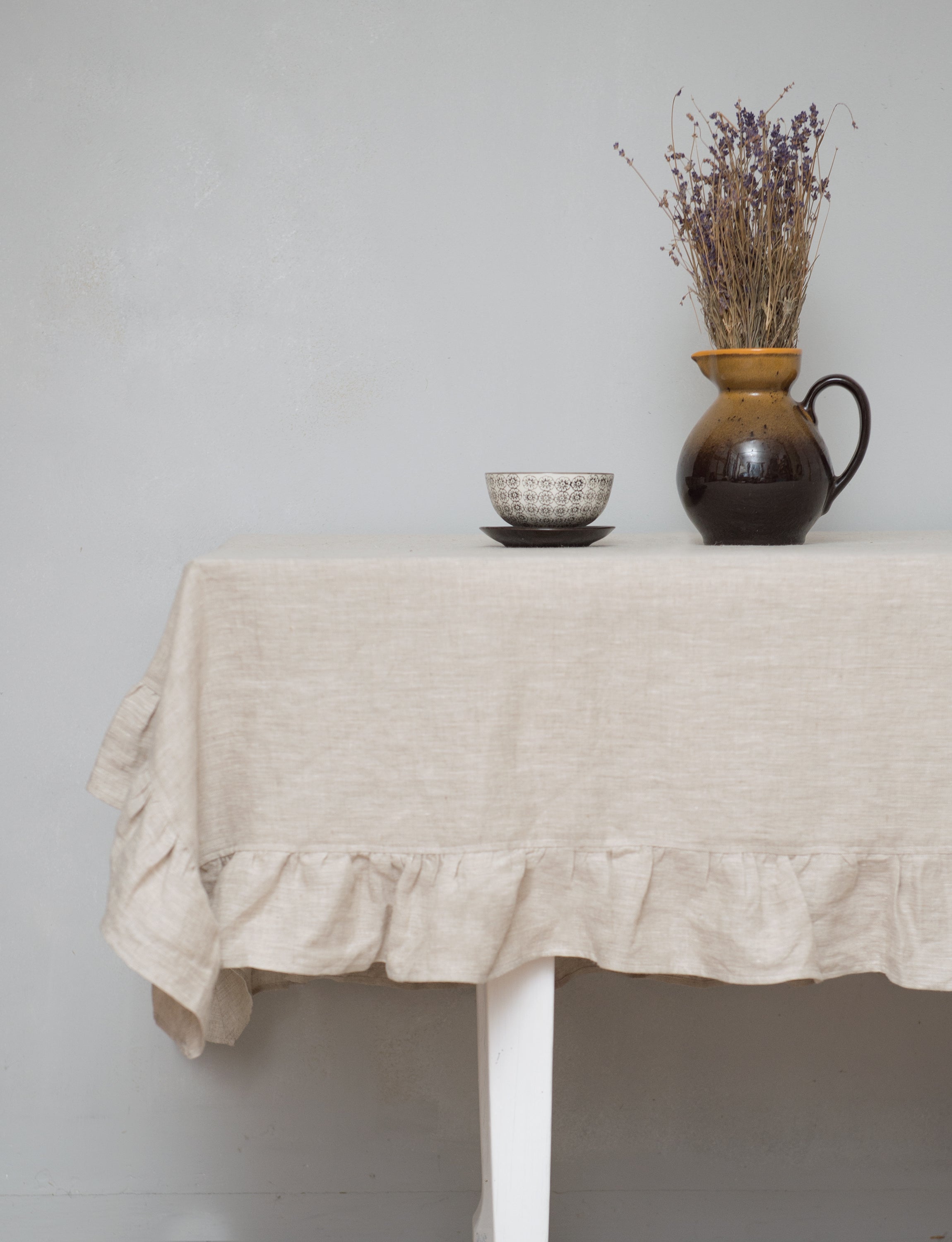 Natural Light linen tablecloth with elegant ruffles, showcasing high-quality European linen in a soft, inviting color.