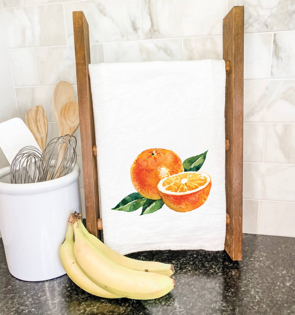 A vibrant cotton tea towel featuring a beautiful orange design, perfect for kitchen use.