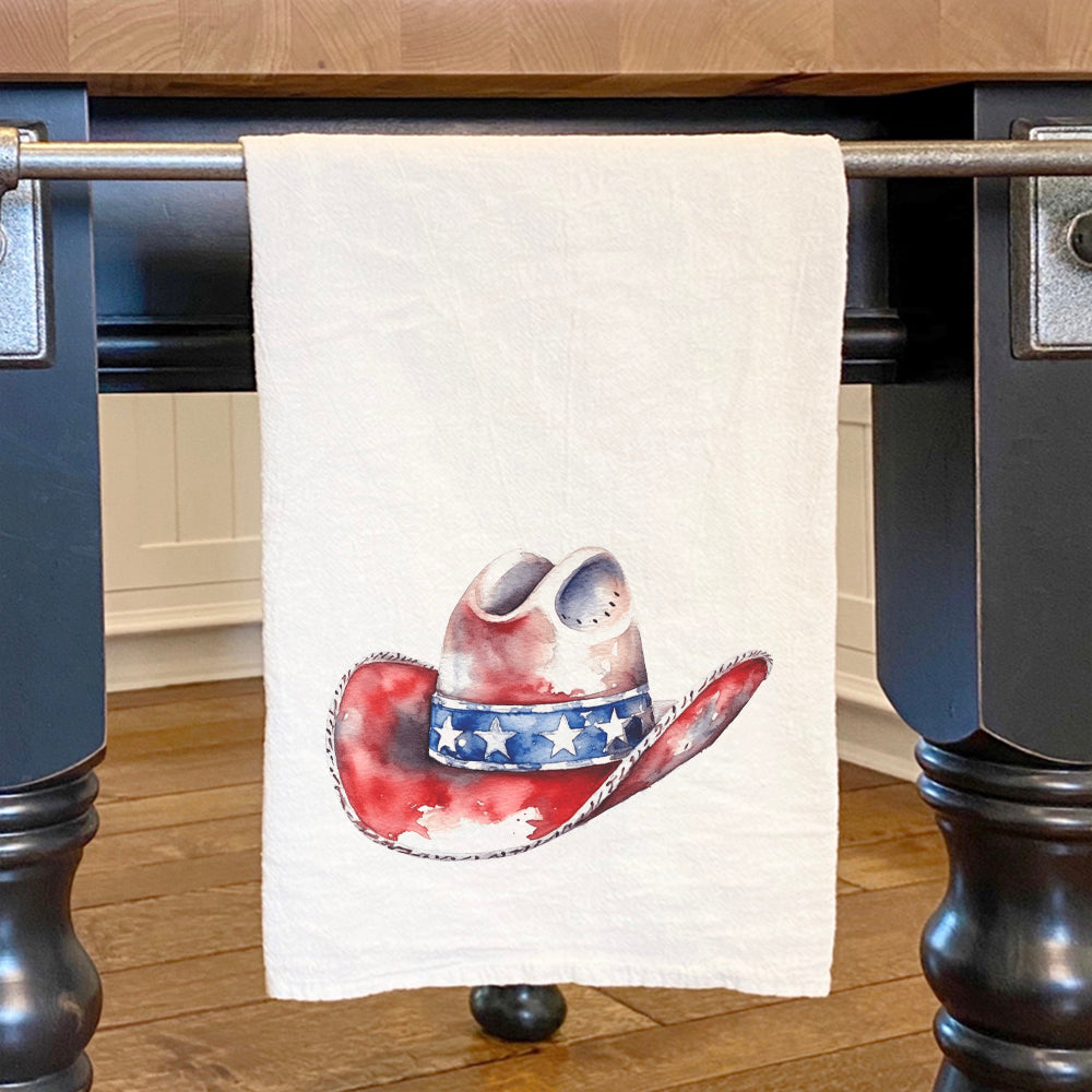 A vibrant cotton tea towel featuring a patriotic cowboy hat design, perfect for kitchen use.